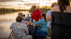 Watch the sun set over Longreach while relaxing on a river cruise