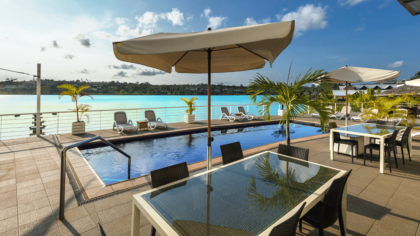 The pool and front facade of the hotel