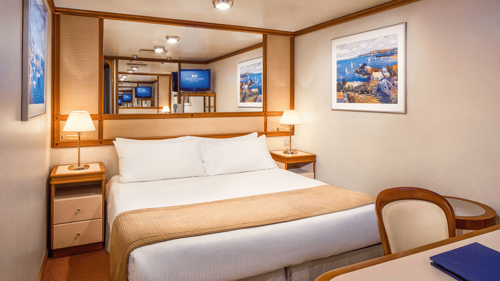 These staterooms are the perfect place to recharge your batteries. Our most affordable option, featuring two twin beds or a queen-size bed. Other amenities include a refrigerator, hair dryer, TV, closet and bathroom with shower.