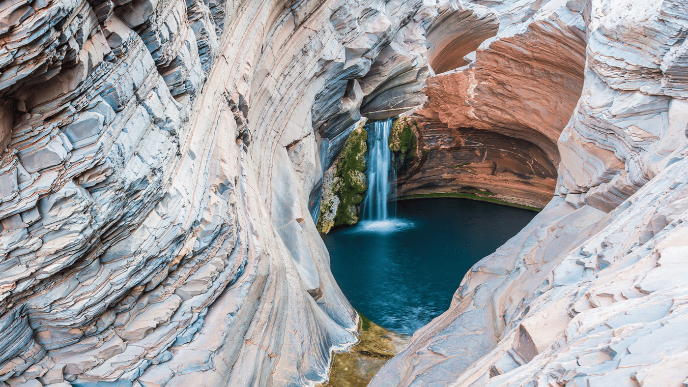 The startling landscape of spectacular gorges, waterfalls and rock pools provides a striking contrast to the stark red landscape of the Pilbara