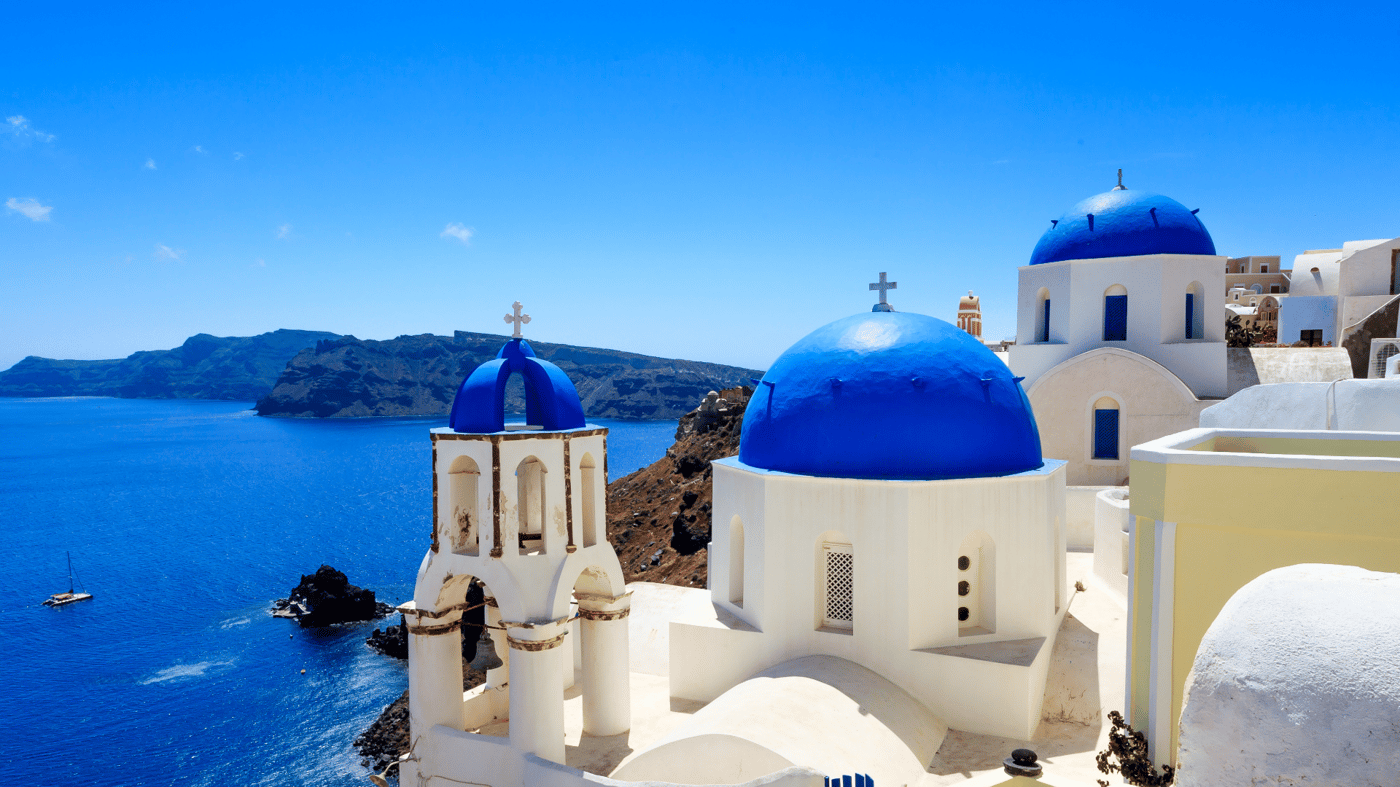 Santorini, where whitewashed buildings cling to vertiginous cliffs that plunge to a turquoise sea.