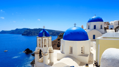 Santorini, where whitewashed buildings cling to vertiginous cliffs that plunge to a turquoise sea.