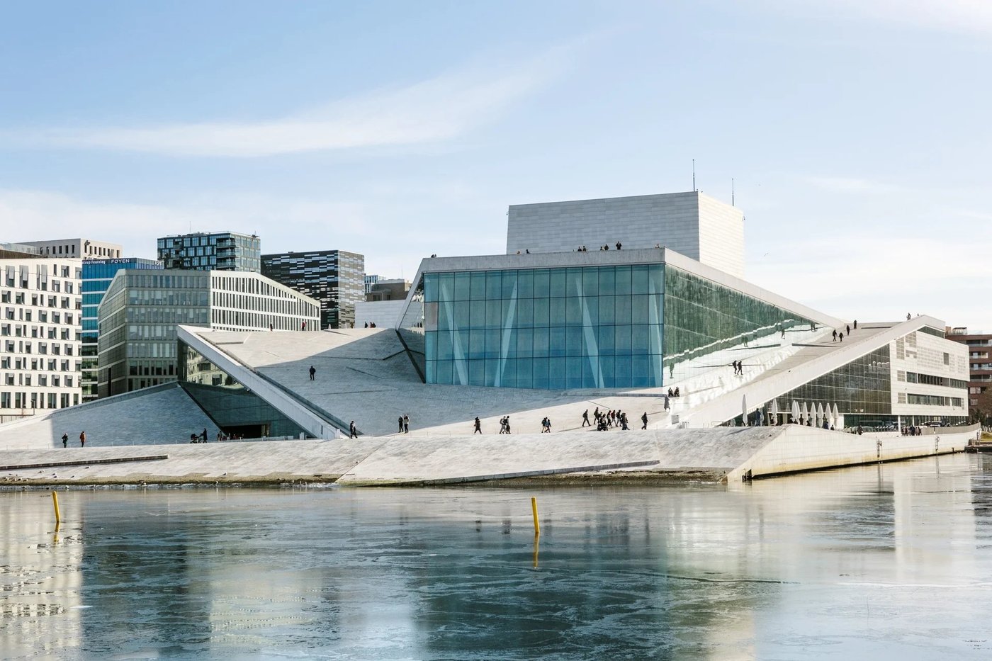 The Oslo Opera House with its distinctive angular architecture viewed from across the harbor.