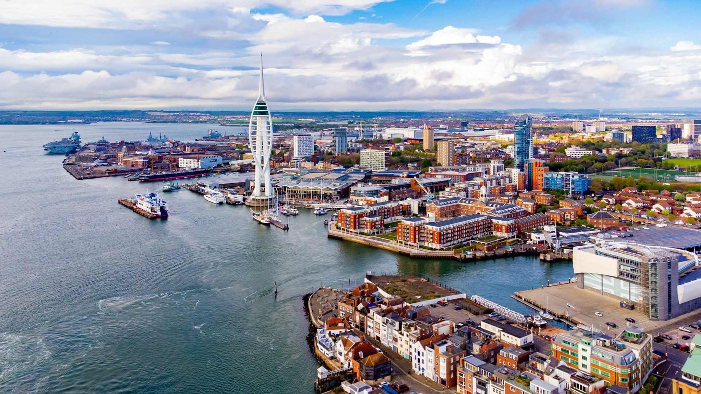 Aerial view of Dublin waterfront showing the Spire and colorful buildings along the River Liffey.