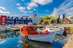 Colorful harbor in Reykjavik with traditional boats and vibrant waterfront buildings.