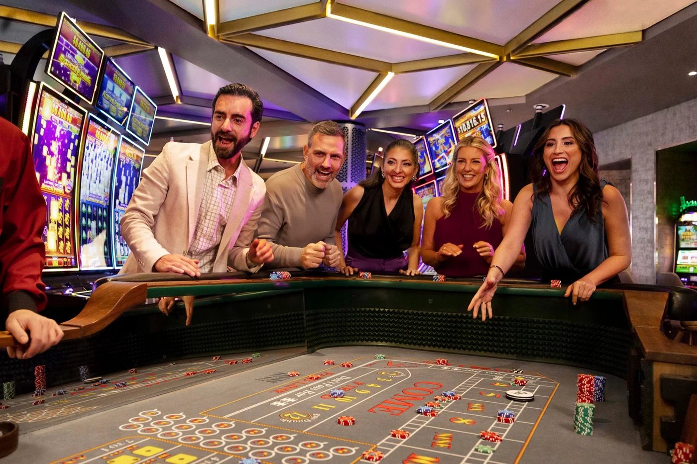Group of guests playing at a casino table aboard the cruise ship.